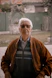 man in brown jacket wearing black framed eyeglasses