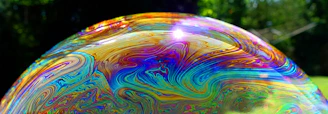 Close-up of a vibrant bottle of ultrabeezie laundry liquid soap with fresh bubbles around it.