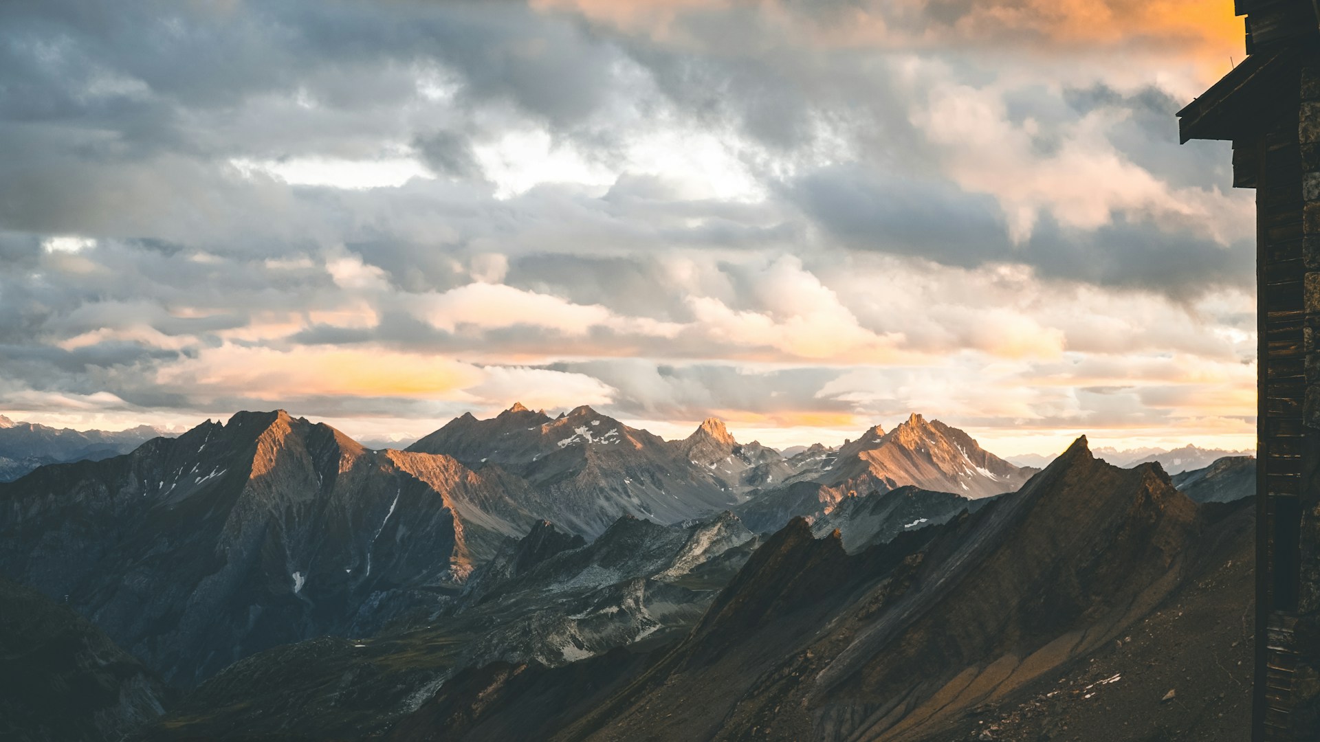 A breathtaking sunset over the Rocky Mountains captured from a drone, highlighting the vibrant colors and rugged peaks.