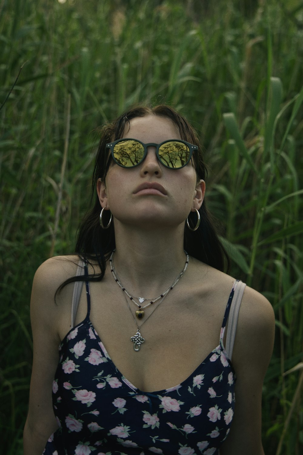 woman in black and white floral tank top wearing black sunglasses