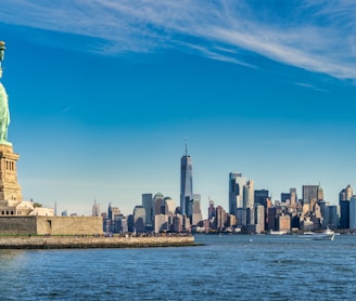 city skyline across body of water during daytime