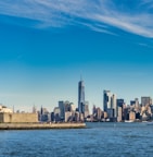 city skyline across body of water during daytime