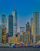 Cityscape at dusk featuring illuminated skyscrapers reflecting a global marketplace.