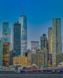 A modern city skyline with high-rise buildings reflecting the evening light.