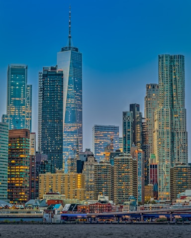 A modern city skyline with high-rise buildings reflecting the evening light.