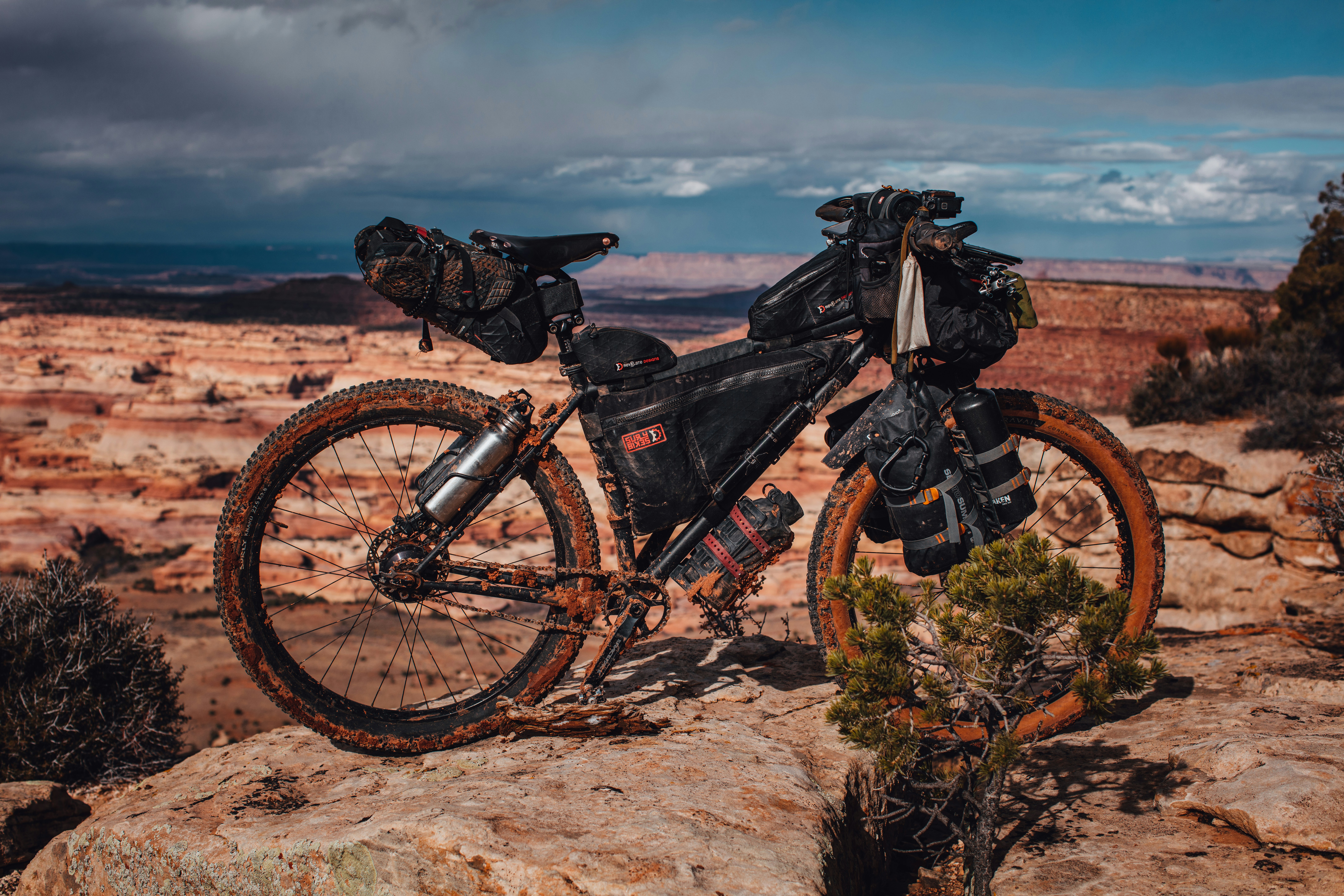 black mountain bike on brown field under gray sky