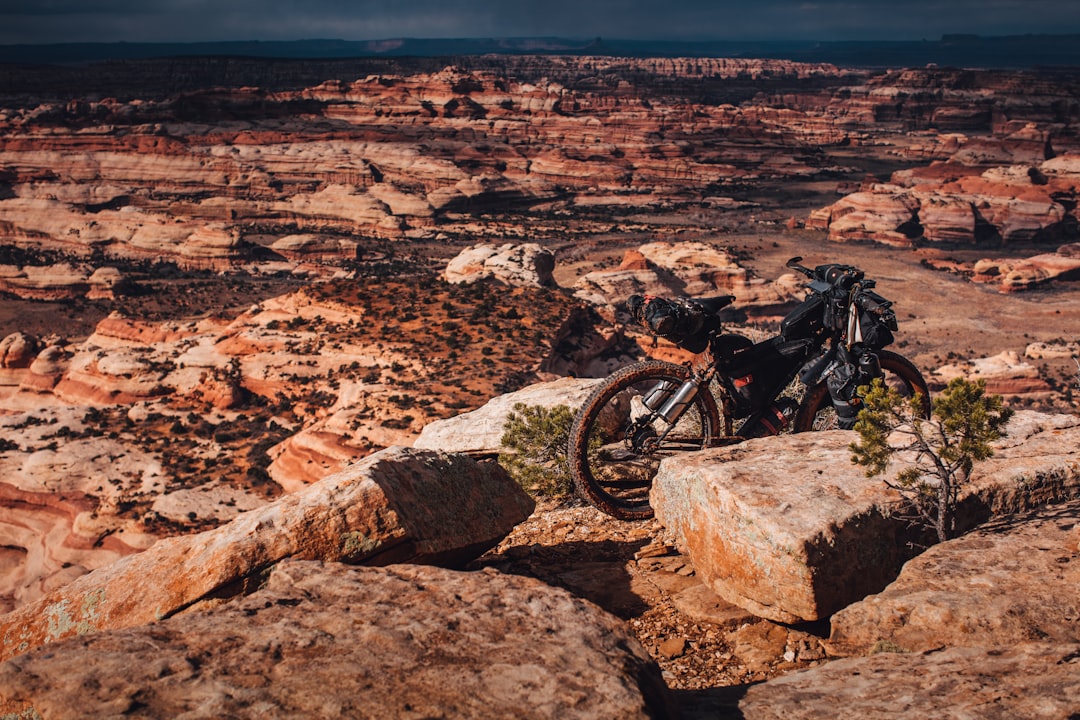 black mountain bike on rocky ground during daytime