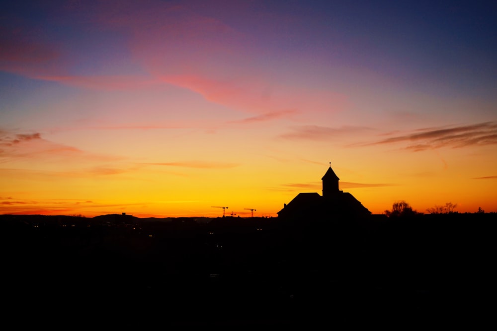 silhouette of building during sunset