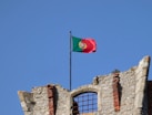 red white and green flag on brown brick wall