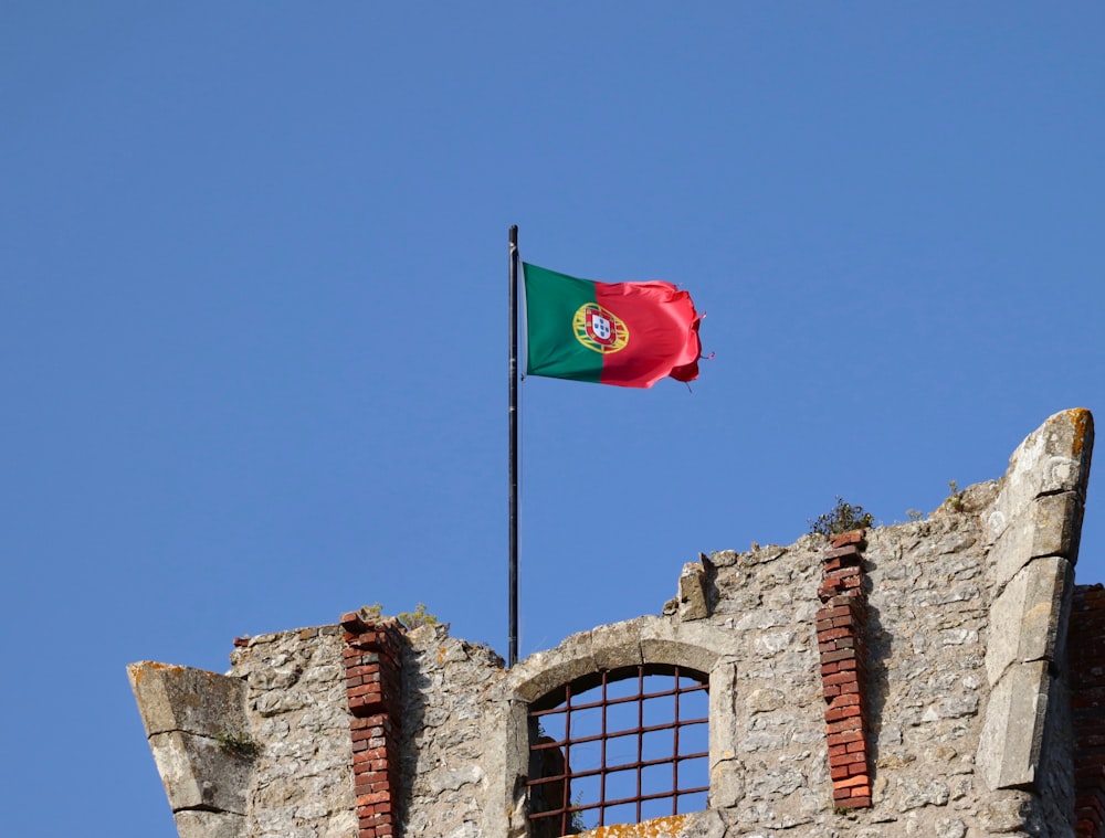 red white and green flag on brown brick wall