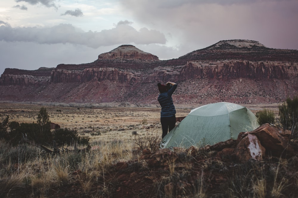 person in black jacket standing near white tent during daytime