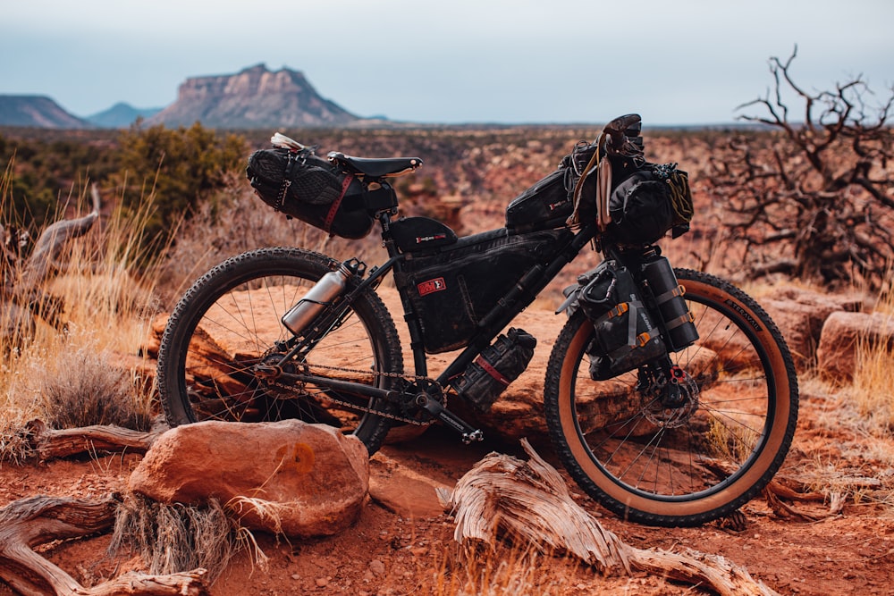 black mountain bike on brown grass field during daytime