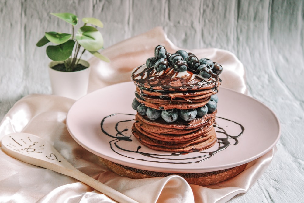 chocolate cake with blue and white icing on white ceramic plate