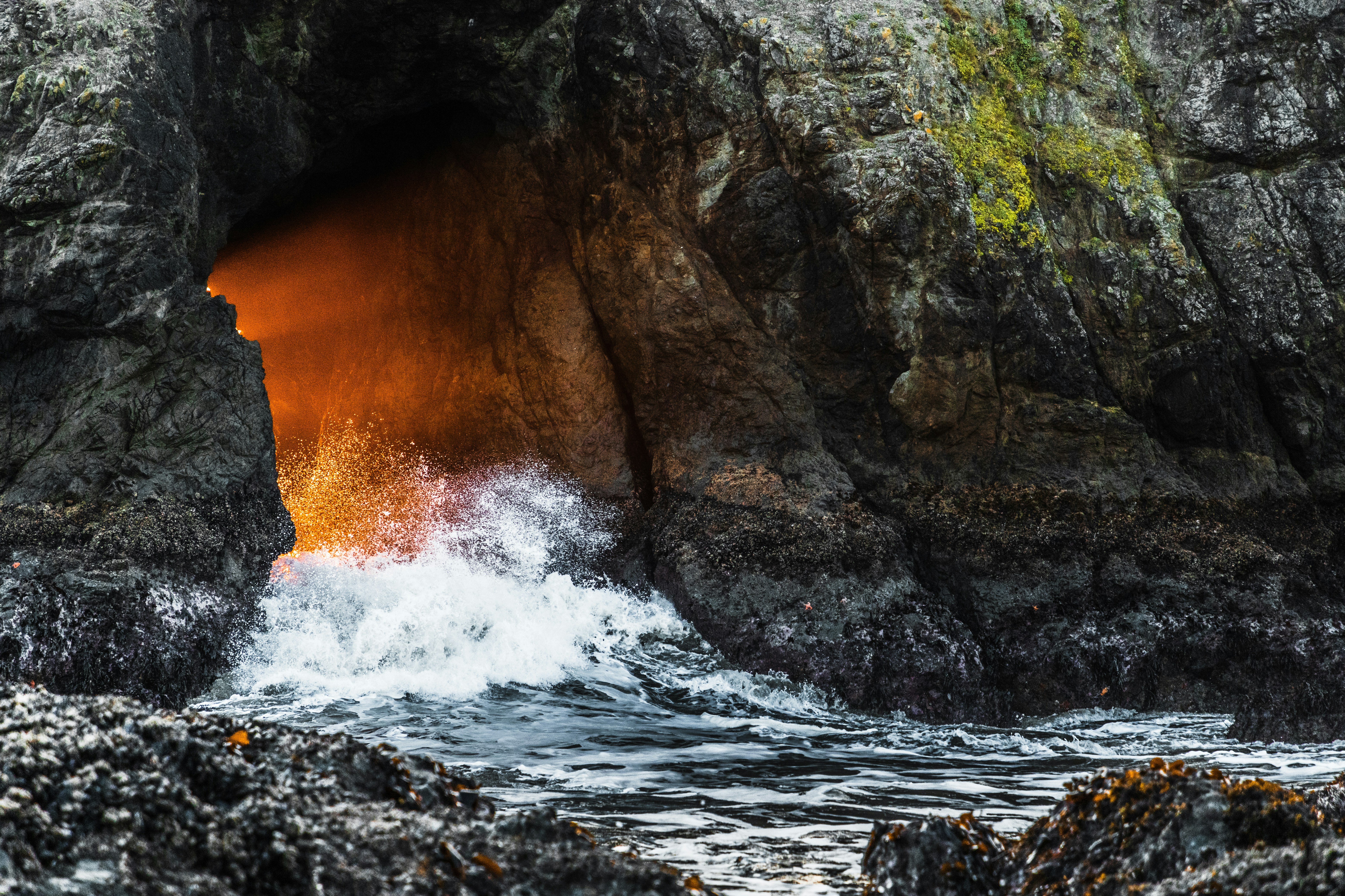water waves hitting rocks during daytime