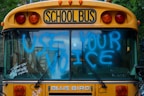 yellow school bus with green and yellow lights