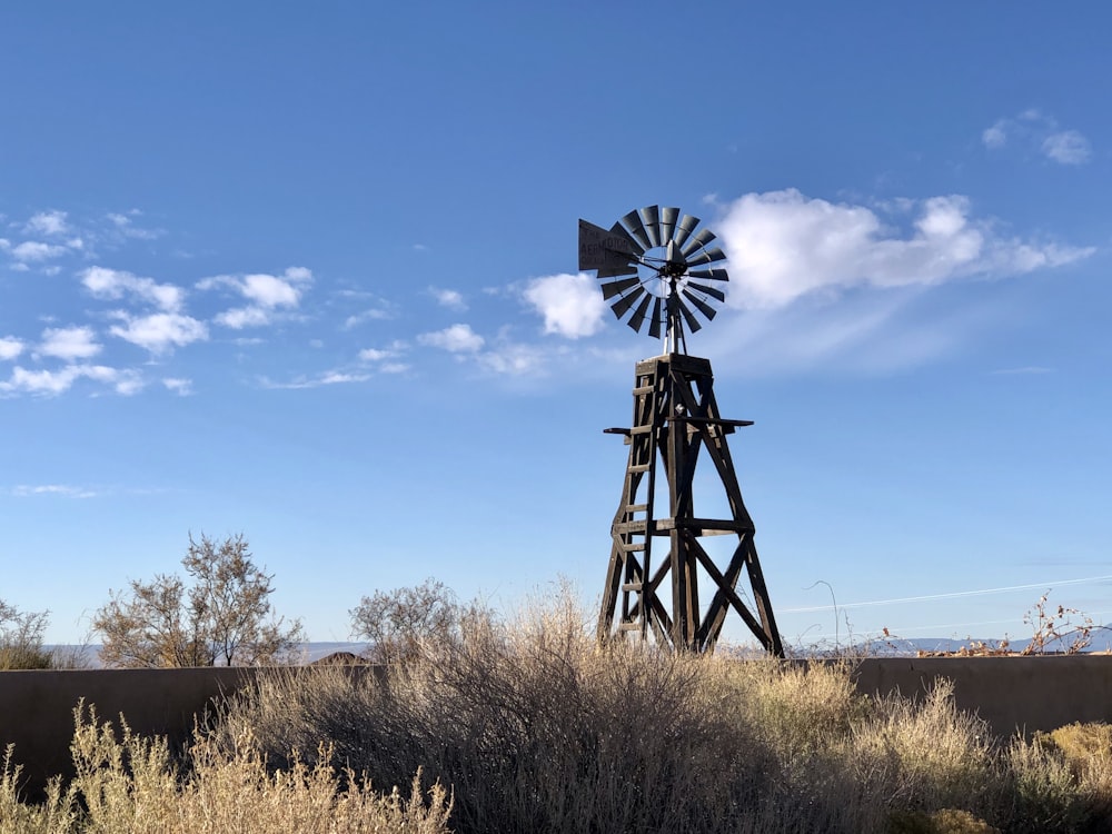 black windmill under blue sky during daytime