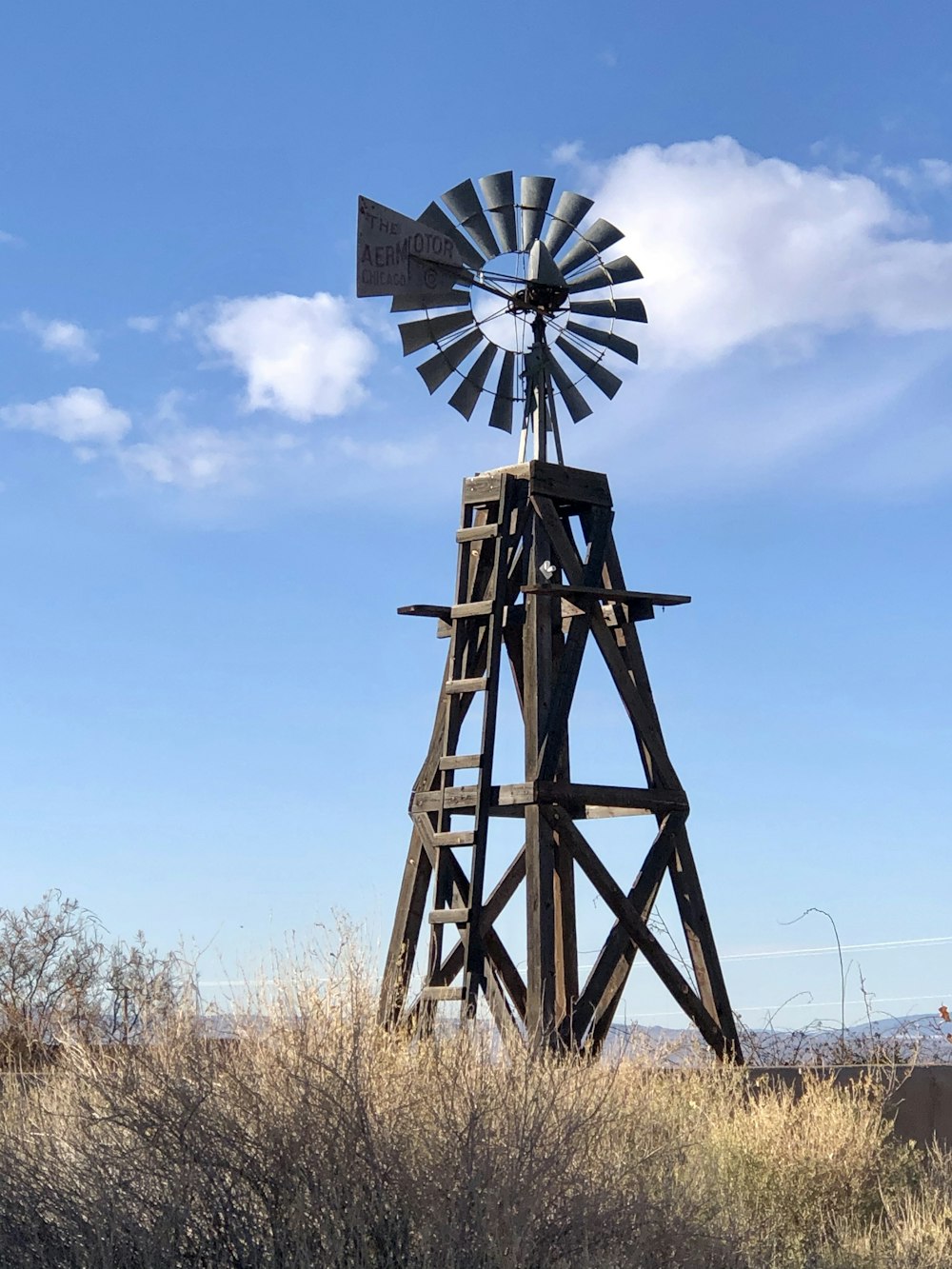 brown windmill under blue sky during daytime