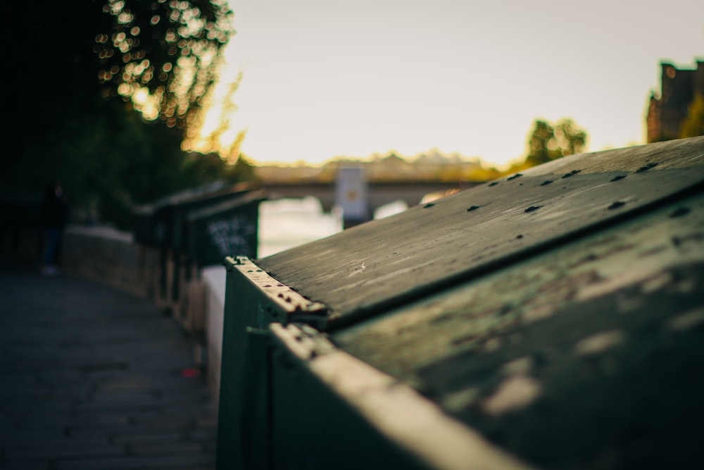 brown wooden fence near green trees during daytime