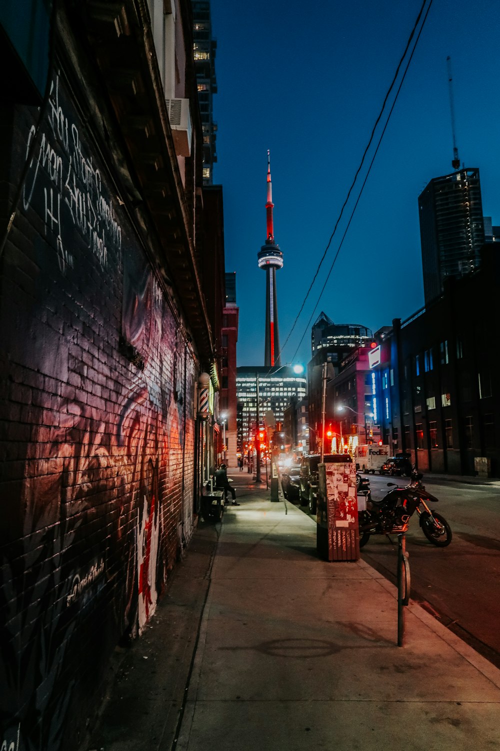 black motorcycle parked beside building during night time