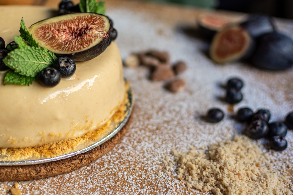 white cake with black berries on top