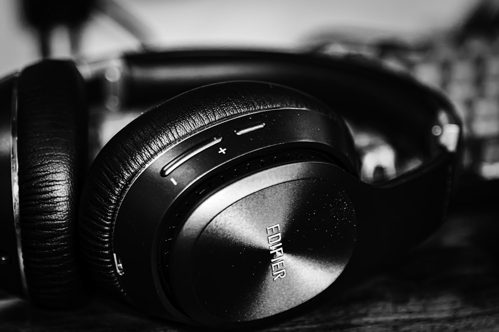 black and silver headphones on black and white piano keys