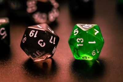 green and black dice on brown wooden table