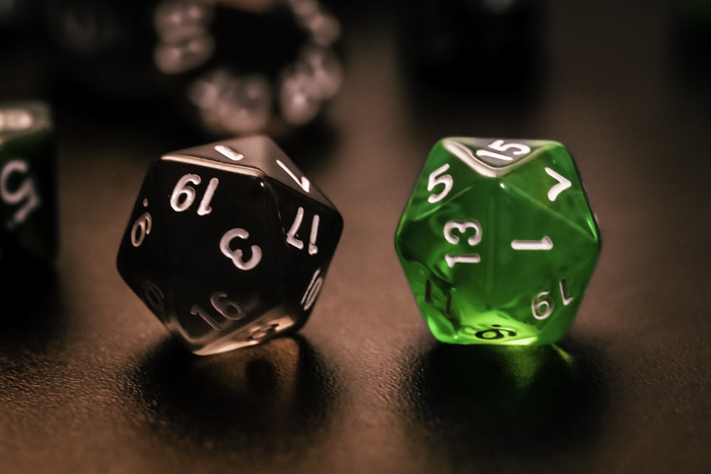 green and black dice on brown wooden table