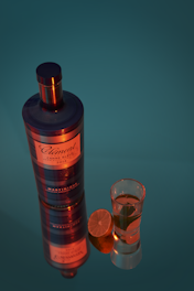a bottle of liquor next to a shot glass