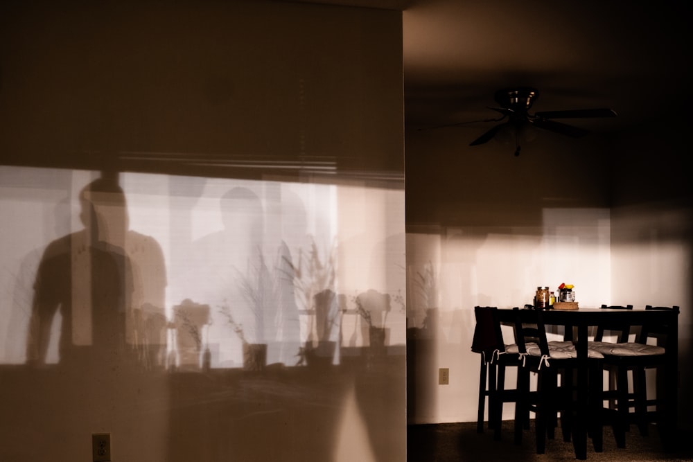 grayscale photo of people standing near table