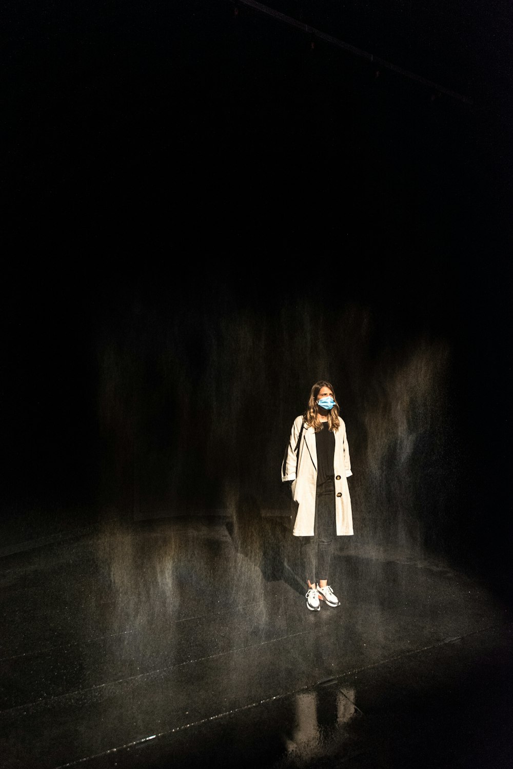woman in white coat standing on tunnel