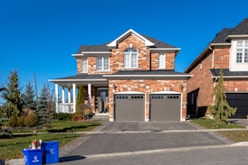 brown and white concrete house under blue sky during daytime