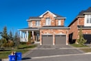 brown and white concrete house under blue sky during daytime