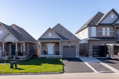 Residential home exterior with new gutters, trimmed roofline, and landscaped front yard