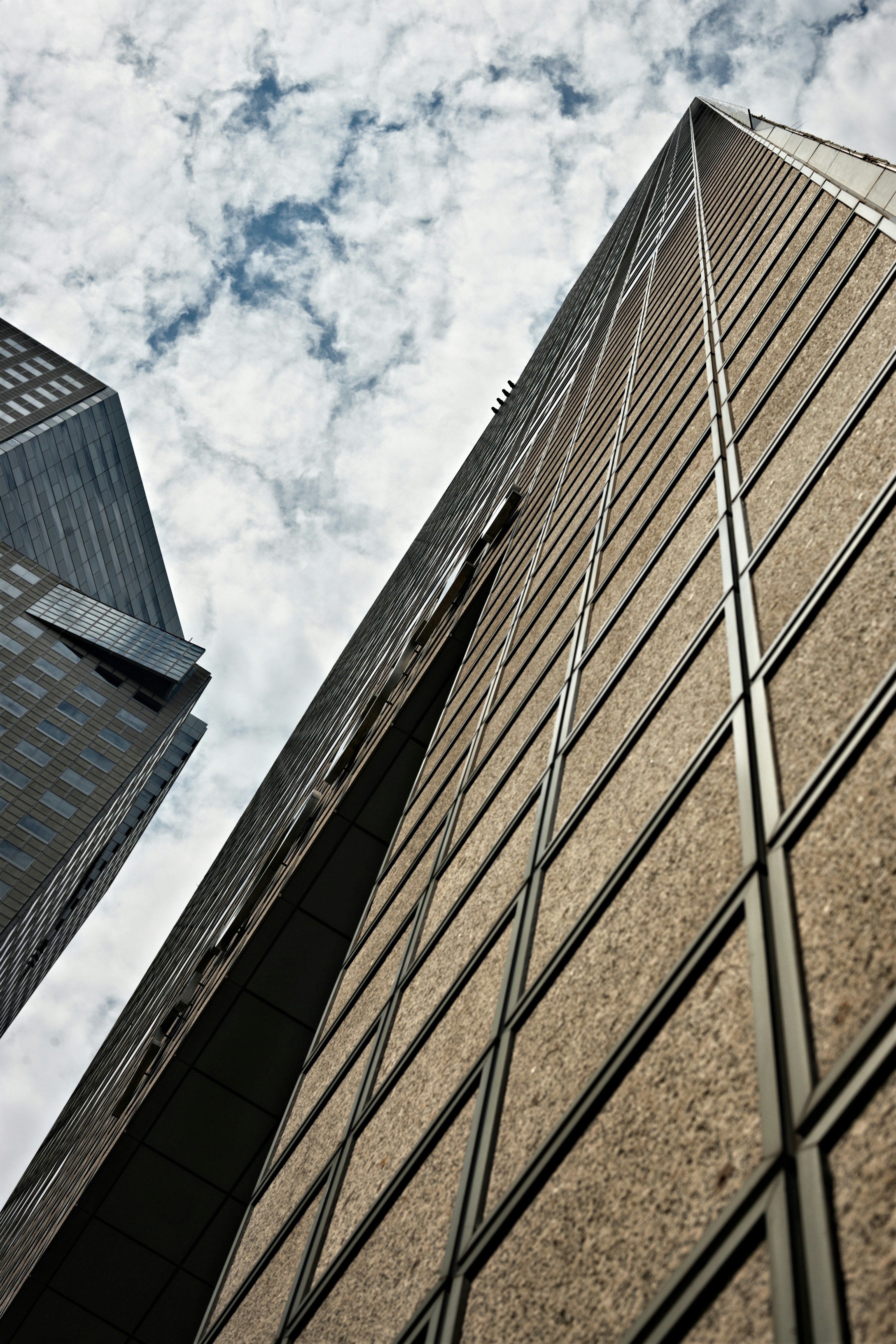 low angle photography of brown concrete building under blue sky during daytime
