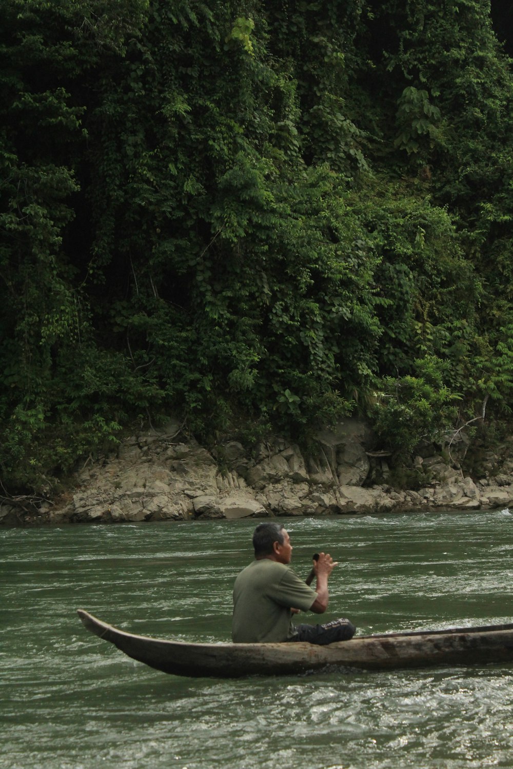 man and woman sitting on boat on river during daytime