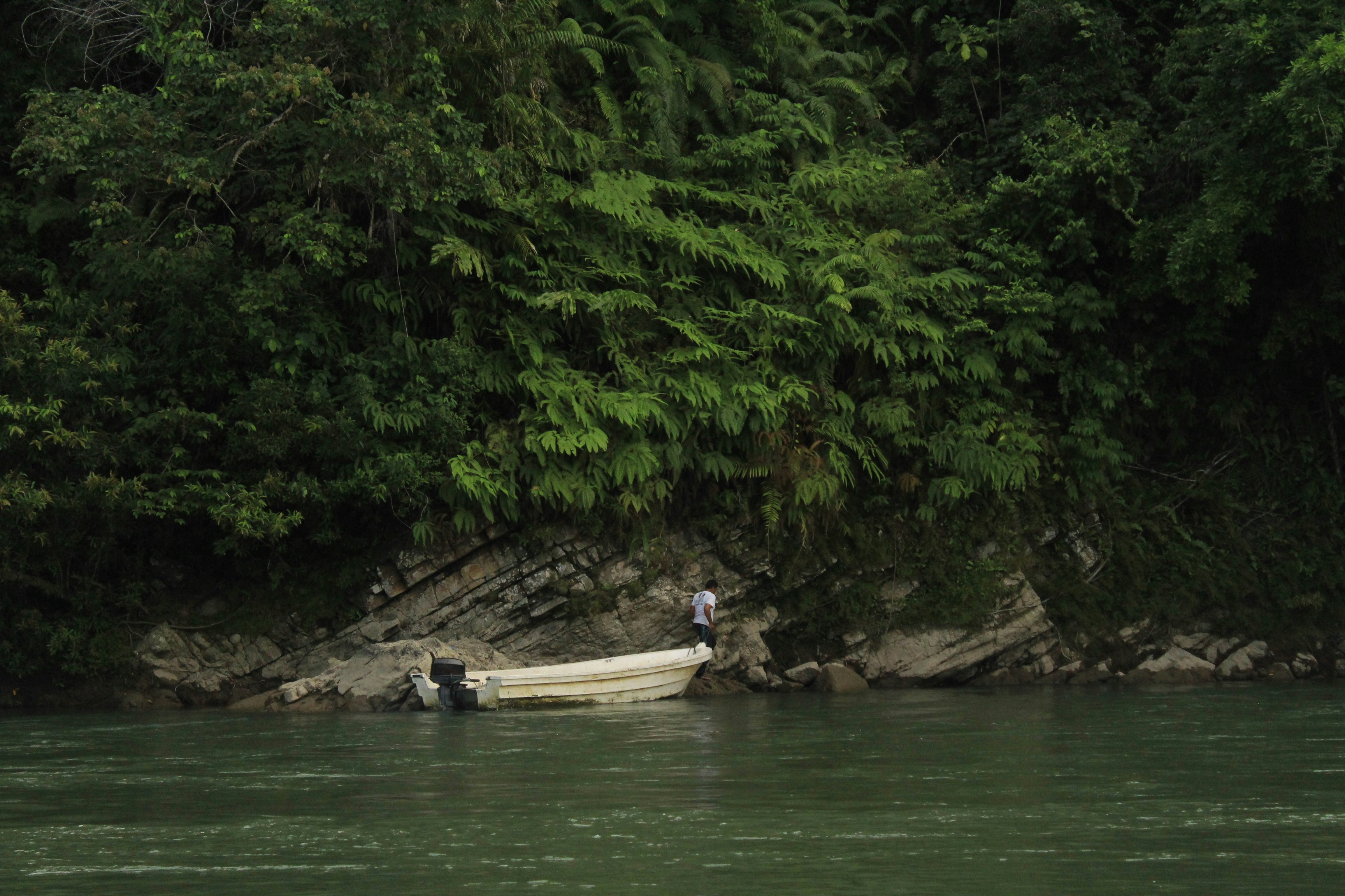 people riding on boat on river during daytime