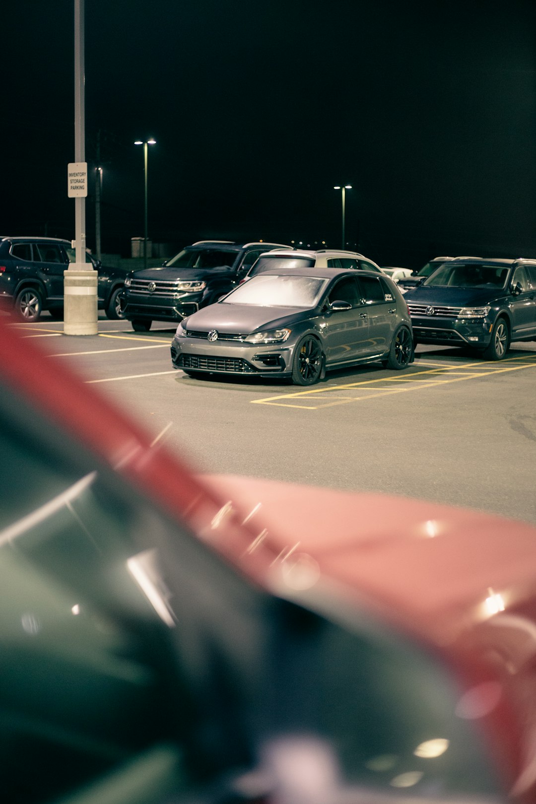cars parked on parking lot during night time