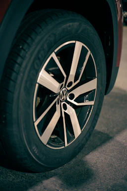 Close-up of a sleek black and red tire tread pattern on a modern car wheel
