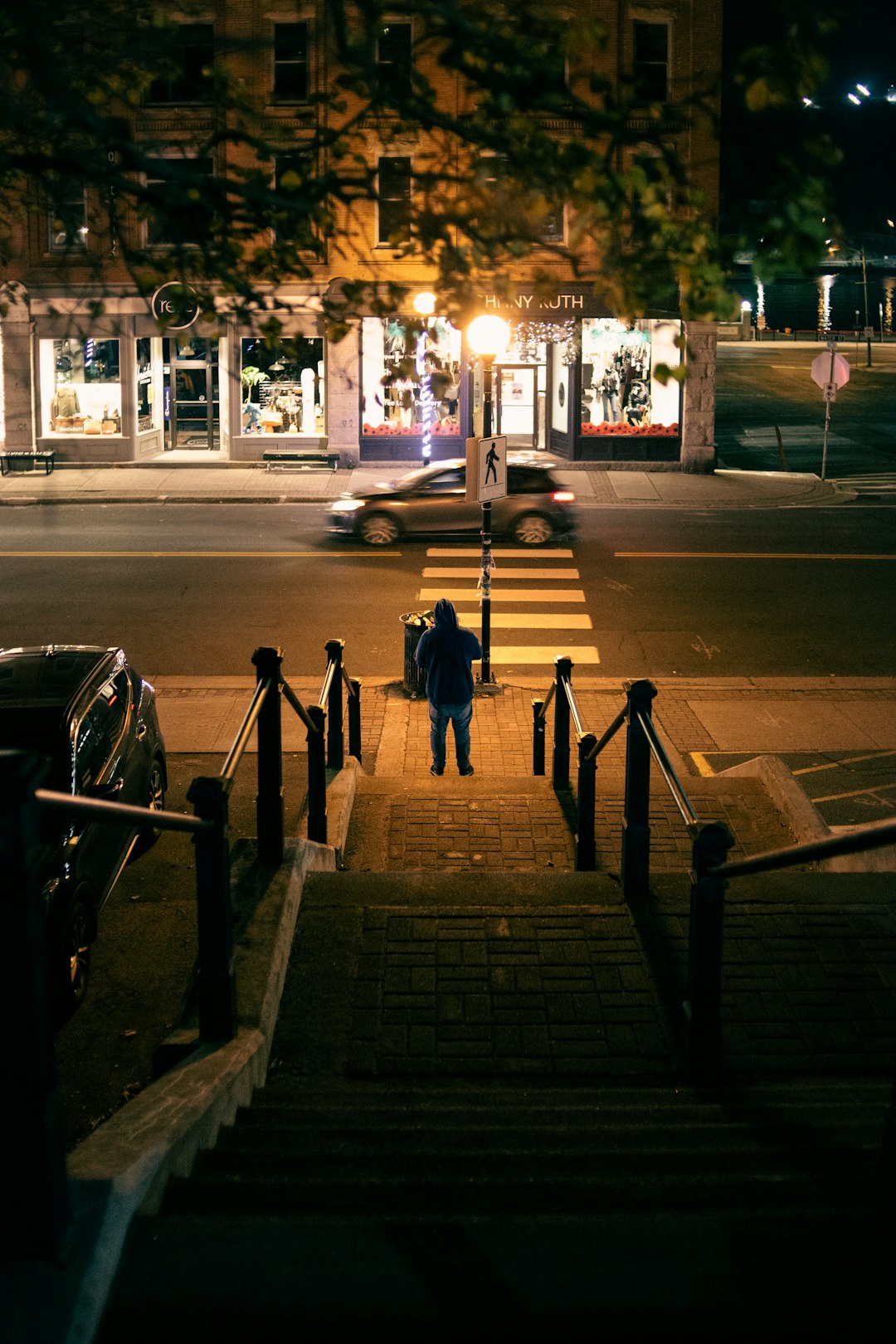 people walking on sidewalk during night time