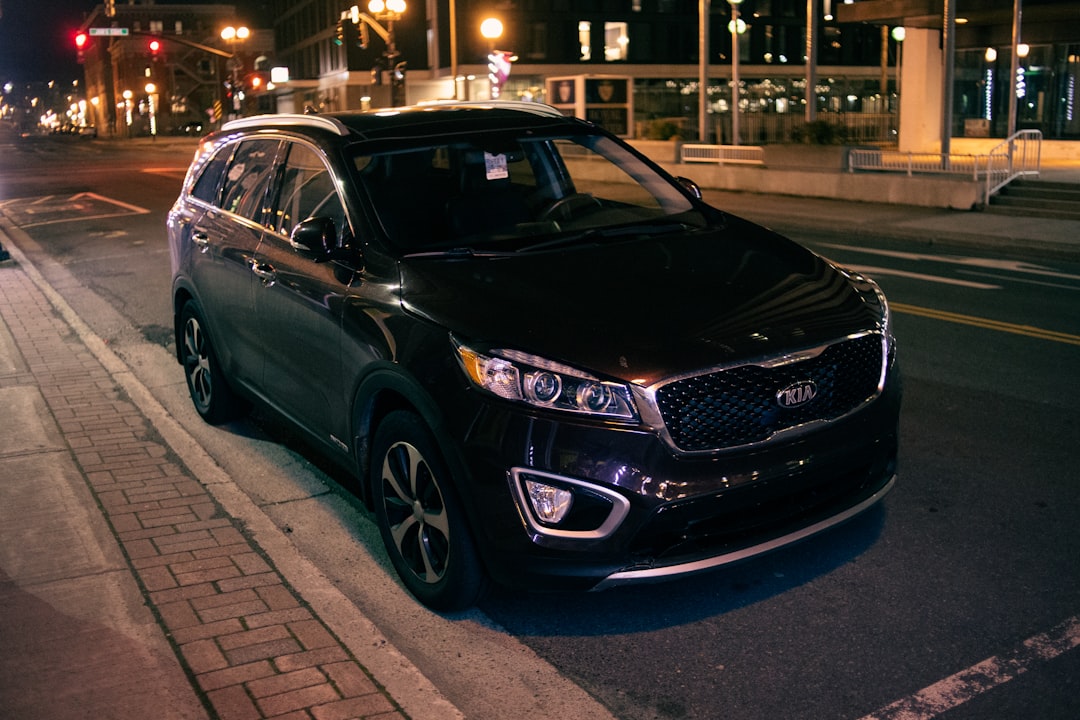 black mercedes benz c class parked on sidewalk during night time