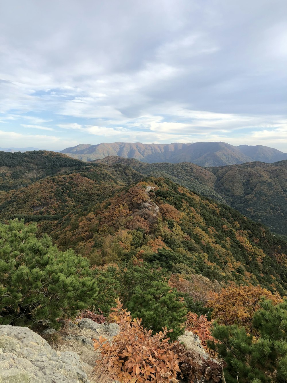 green and brown mountains under white clouds and blue sky during daytime