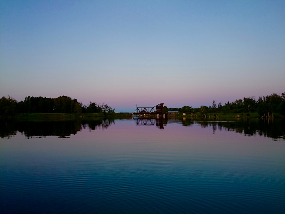 body of water near trees during daytime