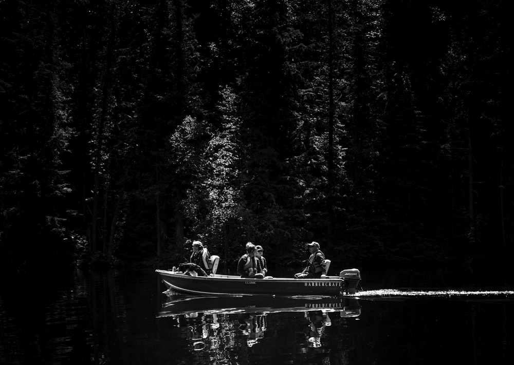 grayscale photo of people in the middle of the forest
