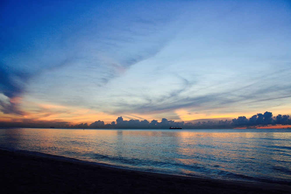 body of water under blue sky during daytime