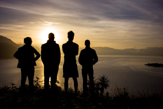 silhouette of 3 men standing on mountain during sunset in Lake Atitlán Guatemala