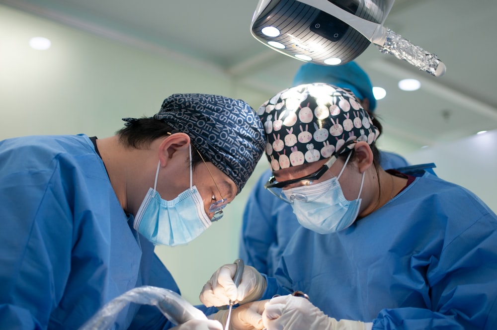 woman in blue scrub suit wearing white mask