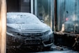 black car covered with snow