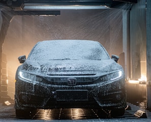 a car is covered in snow in a garage