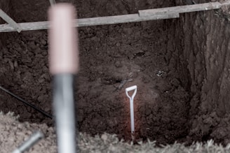 Close-up of excavation tools and uncovered artifacts in a controlled dig.