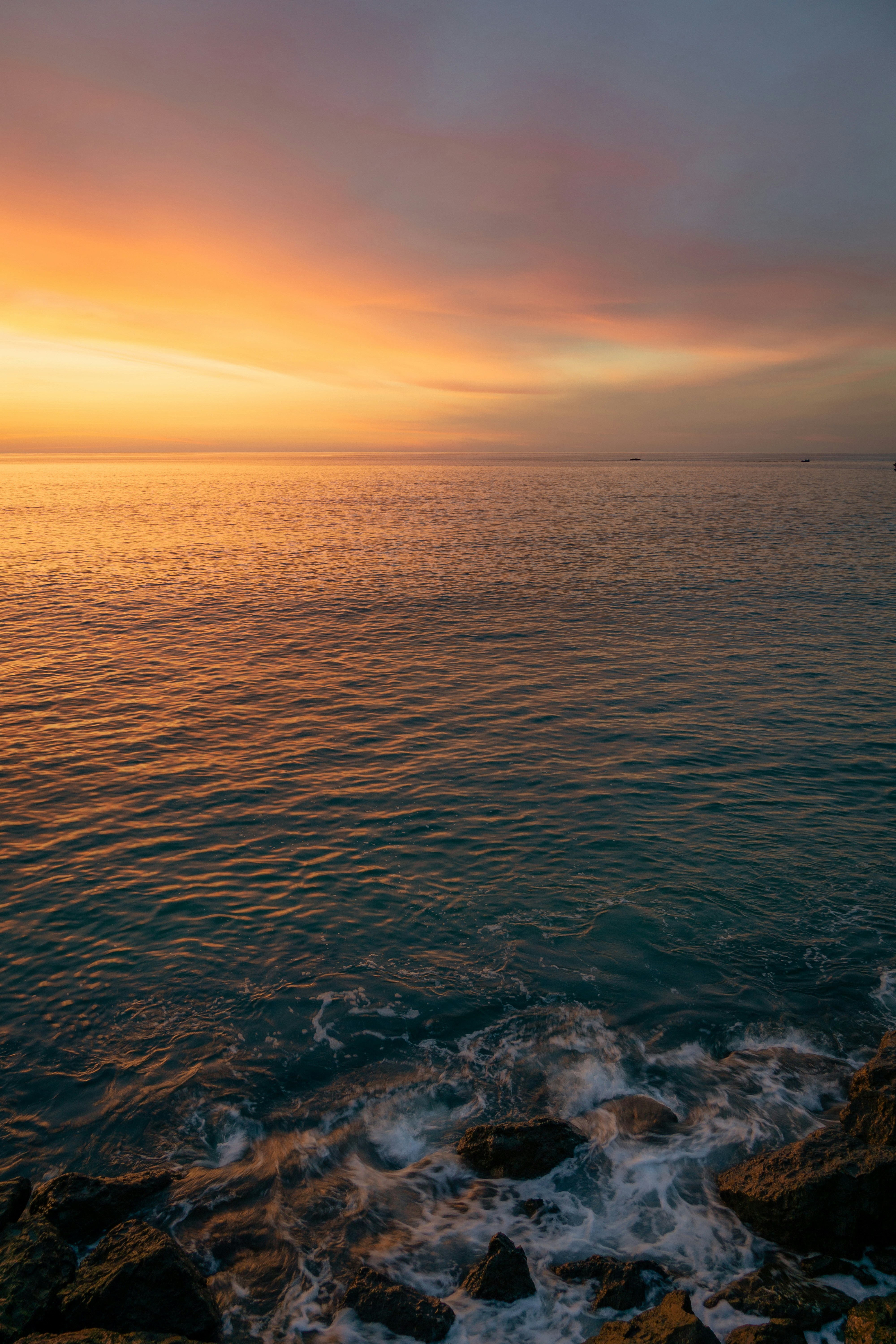 body of water during sunset